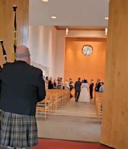 Wedding Bagpiper playing the bride up the aisle in the Ozarks